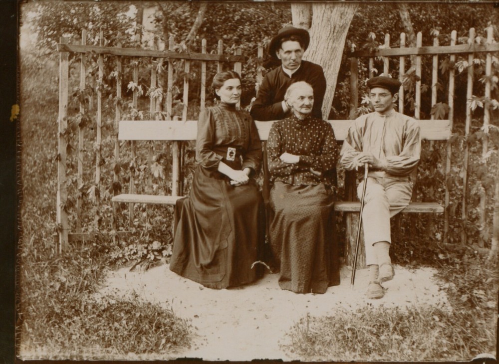M. Pečkauskaitė, S. Pečkauskienė, V. Pečkauskas. Stovi kun. K. Bukontas. Šaukotas. 1909 m.